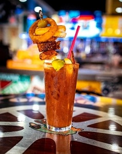 A 22 Ounce Bloody Mary Topped with Grilled Cheese, Wings and More Kicks Off Football Promos at Sickies Garage