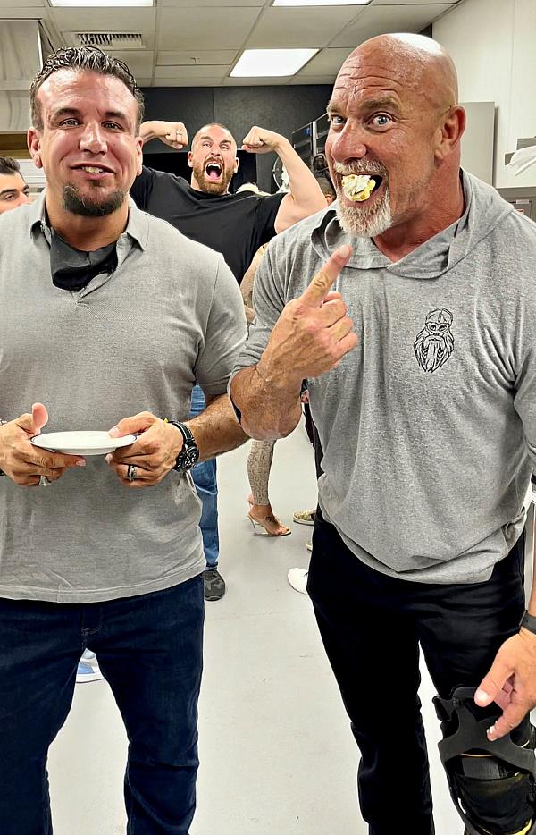 WWE Icon Bill Goldberg with MMA legend Frank Mir enjoying desserts while being photobombed Mojo Rawley  