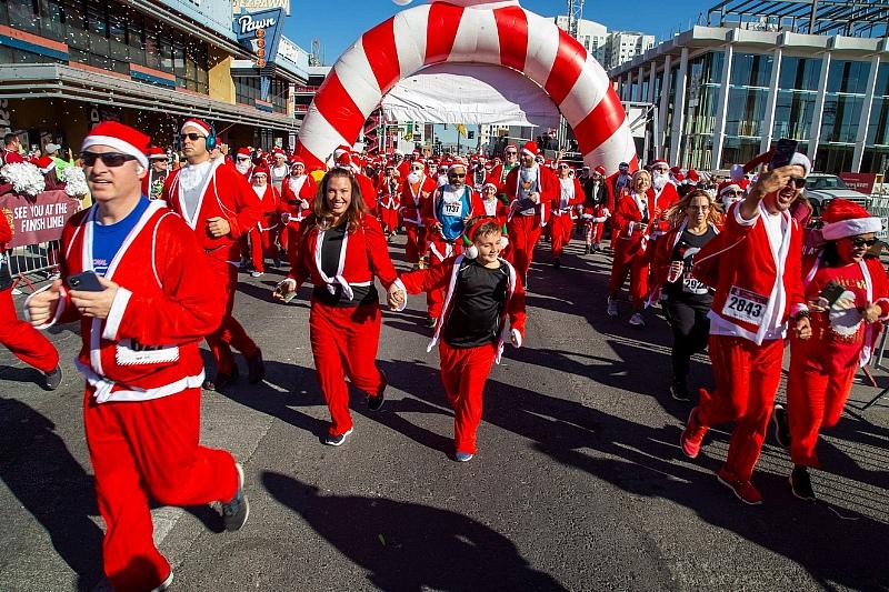 Confetti flies as Santa runners begin their 5k run at the 17th annual Las Vegas Great Santa Run in Downtown Las Vegas