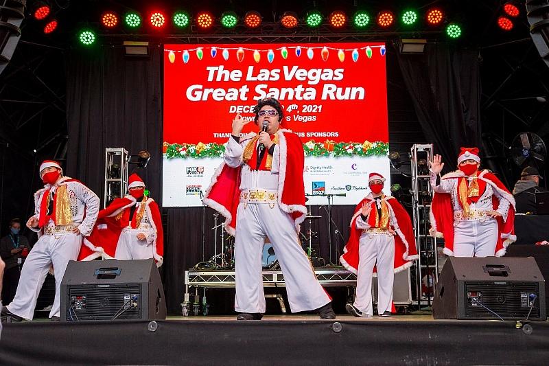 Opportunity Village’s very own all-Elvis singing troupe, The OV Elvi, perform on stage at the 17th annual Las Vegas Great Santa Run in Downtown Las Vegas.
