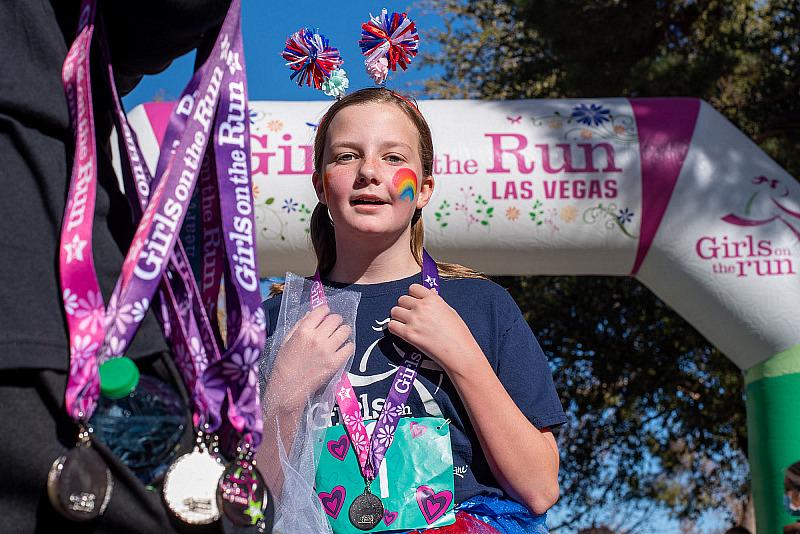 Participant receives medal after Girls on the Run Las Vegas’ Fall 5K