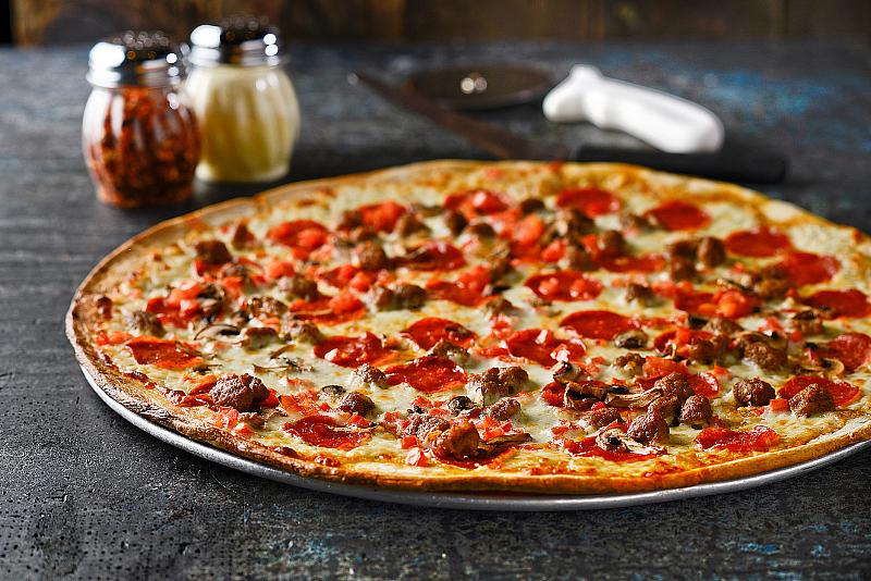  The Gilroy, a pizza topped with pepperoni, Italian sausage, salami, artichoke hearts, onion, garlic white sauce, mushrooms, tomato and mozzarella cheese