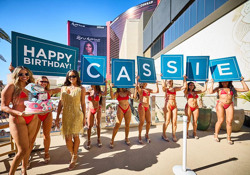  “Happy Birthday Cassie” sign held by bottle service waitresses