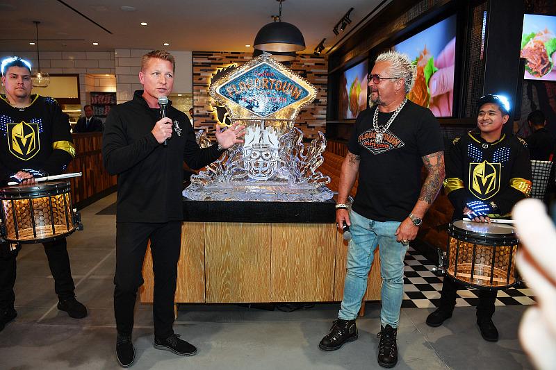 Senior Vice President and General Manager of Horseshoe Las Vegas Jason Gregorec gives celebratory remarks with Guy Fieri at the grand opening of Guy Fieri's Flavortown Sports Kitche