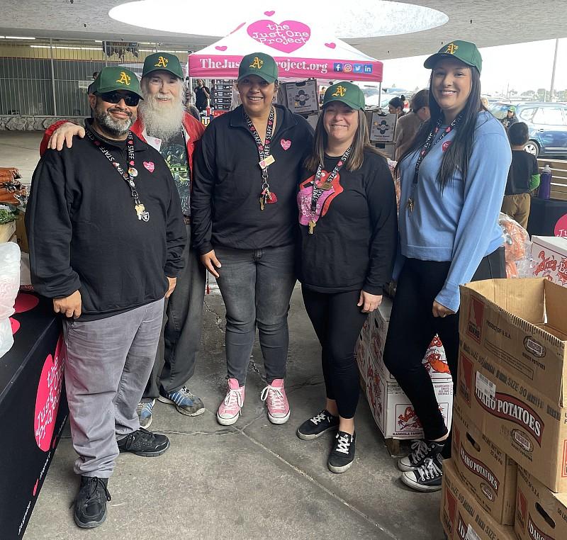 More than 30 volunteers wearing A’s ballcaps, also donated by the team, will be on hand to provide the holiday meals to clients of The Just One Project.
