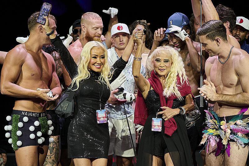 Designers Patricia Adams and Linda Adams and the models celebrate at the finale of the runway for the Naughty Boy Golf fashion show during Swim Week Las Vegas 