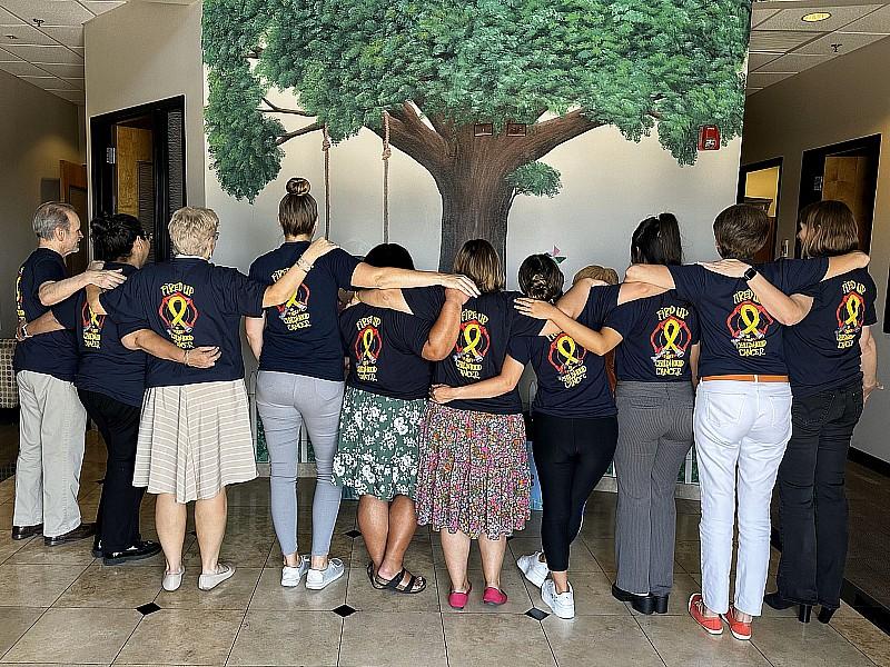 Staff shows off logo t-shirts
